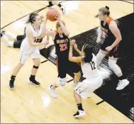  ??  ?? Gravette senior Jessica Bookout grabs a loose ball as Prairie Grove seniors Lexie Madewell (left) and Larisha Crawford (right) converge on her.