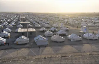  ?? Carl Court / Getty Images ?? Tents are assembled in the Debaga refugee camp for families displaced by the fight for Mosul. Iraqi forces launched a major offensive last week aimed at retaking the city from militants.