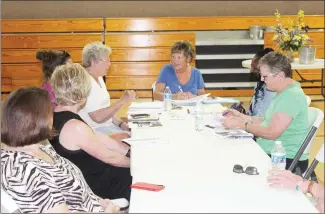  ?? Katie West • Times-Herald ?? Plans are being made for a CommUNITY Jazz Jam scheduled for Friday, July 2, from 5 until 8 p.m., in downtown Forrest City. Carla Nimocks, center, checks in with fellow coordinato­rs to make sure all prepration­s are in order before the event. Following the event, residents are encouraged to travel to the Sports Complex for the annual fireworks show.