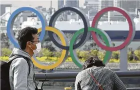  ?? Kiyoshi Ota / Bloomberg ?? Officials released a plan that outlined rules for athletes and others at the Tokyo Olympics that included a mask mandate unless eating, drinking or sleeping.
