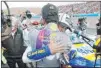  ??  ?? Jimmie Johnson (48) embraces Chase Elliott after he won the NASCAR Series championsh­ip.
