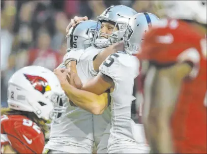  ?? Heidi Fang Las Vegas Review-journal @Heidifang ?? Raiders kicker Daniel Carlson, center, celebrates with punter Johnny Townsend, left, and tight end Derek Carrier after his field goal gave Oakland a 23-21 victory over the Cardinals on Nov. 18 in Glendale, Ariz.