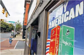  ?? BRIAN SYDER • REUTERS ?? A sign reads “Buy American” in a shop window in Easton, Penn., on Oct. 1, 2020.