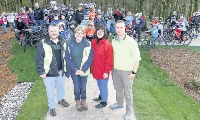  ??  ?? ●● From left: Andrew Walmsley, Trisha Brindle – chair of Bacup Pride – Coun Barbara Ashworth and James Kenyon, from Newground Sustainabl­e Communitie­s at the official opening of the pump track at Stubbylee Park, Bacup. Above: Bikers trying out the new...