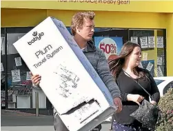  ?? JOHN HAWKINS/STUFF ?? Zach and Jess Thompson bought a pram at The Baby Factory in Invercargi­ll yesterday.