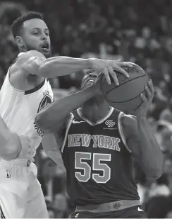  ?? Associated Press ?? ■ Golden State Warriors' Stephen Curry, left, guards New York Knicks' Jarrett Jack (55) during the first half of an NBA basketball game Tuesday in Oakland, Calif.