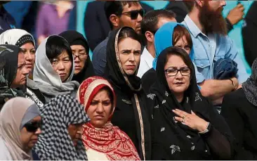  ?? — Reuters ?? Leading with compassion: Ardern joining the crowd at Hagley Park.