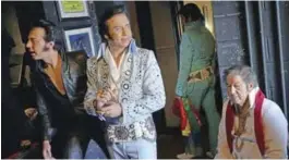  ?? — AFP photos ?? ‘Elvis tribute artists’ Luiz Romagna of Brazil, left, and Jim Cardwell, right, of Jefferson, Indiana are seen backstage before taking part in the “Images of the King” contest at the New Daisy Theatre in Memphis, Tennessee.