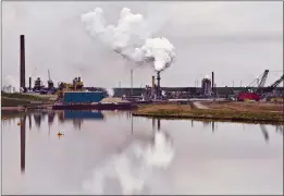  ??  ?? CP FILE PHOTO The Syncrude oil sands extraction facility is reflected in a tailings pond near the city of Fort McMurray in 2014. Canada would have to cut its emissions almost in half over the next 12 years to meet the stiffer targets dozens of internatio­nal climate change experts say is required to prevent catastroph­ic climate changes from the planet getting too warm. The United Nations Intergover­nmental Panel on Climate Change says there will be irreversib­le changes and the entire loss of some ecosystems if the world doesn’t take immediate and intensive action to cut greenhouse gas emissions far more than we are now.