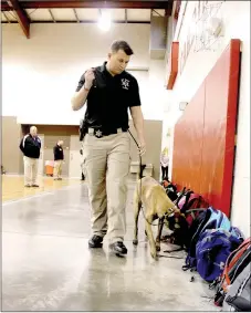  ?? LYNN KUTTER ENTERPRISE-LEADER ?? K9 officer Rickie, a Belgium Malinois, sniffs students’ backpacks Monday morning prior to the start of the day at Lynch Middle School. All students were sent to the gym where they placed their backpacks against the wall. The middle school had a threat...