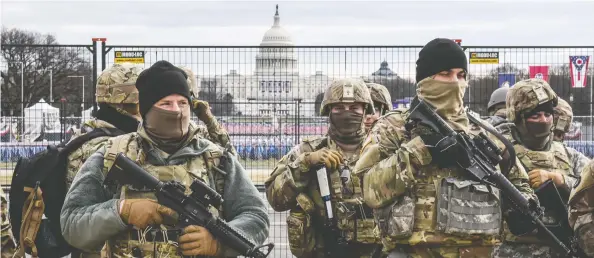  ?? STEPHANIE KEITH / GETTY IMAGES ?? National Guard patrol Washington's National Mall on Tuesday, as fears of pro-Trump violence prompted tight security before Joe Biden's inaugurati­on.