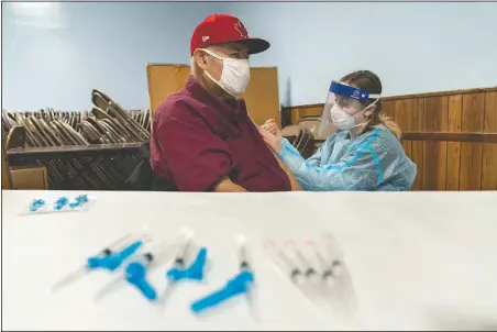  ?? (AP/David Goldman) ?? Mario Valdez, 62, receives his first shot of a vaccine at a clinic in Central Falls, R.I. “I feel happy,” the 62-year-old school bus driver said shortly after receiving his second and final dose five weeks later. “Too many people here have covid. It’s better to be safe.”