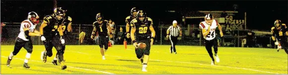  ?? MARK HUMPHREY/ENTERPRISE-LEADER ?? Scramble for the football. Prairie Grove senior Dustin Burton pursues a punt blocked by teammate Isaac Disney (far recovered for the Tigers during Prairie Grove’s 42-21 Homecoming win Oct. 14. right) with Pea Ridge punter Robby Pickthall also in the...