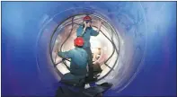  ?? PHOTOS PROVIDED TO CHINA DAILY ?? Despite difficulti­es and challenges, builders manage to complete water tunnels to a tight schedule.