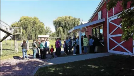  ?? SARATOGIAN FILE PHOTO ?? People stand in line for tasty apple cider donuts at Hick’s Orchard in Granville. A recent business course gave farm owners tips for more successful sales and marketing.