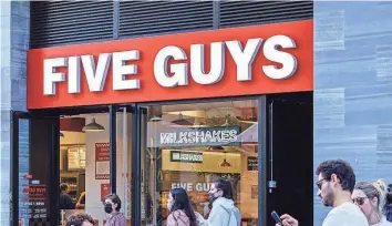  ?? GETTY IMAGES ?? Five Guys’ prices “are out of control,” wrote X user Wall Street Silver, along with a receipt totaling $24.10 for a bacon cheeseburg­er, a soda and a small order of fries.