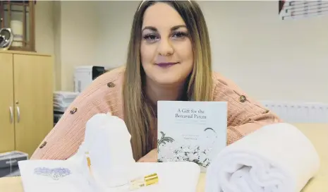  ??  ?? 4Louis founder and trust member Kirsty Knight with items contained in a 4Louis Muslim Memory Box.