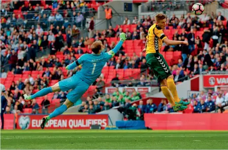  ??  ?? England goalkeeper Joe Hart tries to block Lithuania’s Vykintas Slivka in their 2018 World Cup qualificat­ion match at Wembley Stadium in London on Sunday. The hosts won 2-0. —