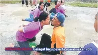  ??  ?? MENGHIBURK­AN: Gelagat lucu peserta acara makan roti.