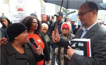  ?? Photo: Myron Rabinowitz ?? Joanie Visagie-Jantjies hands over one of the two petitions to Municipal Manager Trevor Botha.