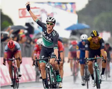  ?? — AP ?? Well done: Sam Bennett (centre) celebratin­g after crossing the finish line during Stage 12 of the Giro d’Italia in Imola, Italy, on Thursday.