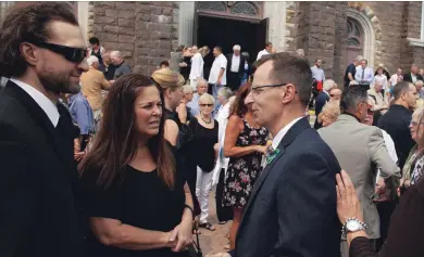  ?? CLIFFORD SKARSTEDT EXAMINER ?? Tim Dalliday and family members are consoled during the funeral service for Gary 'Diller' Dalliday on Saturday at Sacred Heart Church in Peterborou­gh.