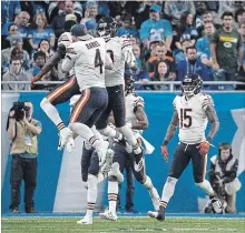 ?? DAVE REGINEK GETTY IMAGES ?? Eddie Jackson of the Bears celebrates his intercepti­on for a touchdown in the fourth quarter with teammates. The Bears won the game, 23-16.