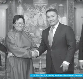  ??  ?? A. D. Tsendina (left) shaking hands with President Kh.Battulga