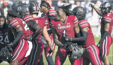  ?? SEAN RAYFORD — THE ASSOCIATED PRESS ?? South Carolina defensive back Jaycee Horn, middle, celebrates with teammates after beating No. 15 Auburn Saturday.