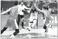  ?? AP/Ng Han Guan ?? United States’ Khris Middleton tries to get past Turkey defenders on Tuesday during a Group E match for the FIBA Basketball World Cup at the Shanghai Oriental Sports Center in Shanghai.