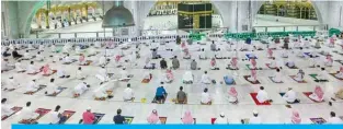  ?? — AFP ?? MAKKAH: Saudis and expats perform Fajr prayers at the Grand Mosque for the first time after easing months-long COVID-19 restrictio­ns.