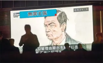  ?? BEHROUZ MEHRI/AFP ?? Pedestrian­s pass by a television screen showing a news programme displaying a sketch of former Nissan chief Carlos Ghosn in the Tokyo courtroom on Tuesday.