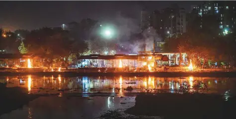  ?? PTI ?? Funeral pyres at the Bhaisakund cremation ground in Lucknow tell a story starkly different from the government claims. After images of burning pyres went viral, authoritie­s on Thursday got the cremation ground fortified with tin sheets to block the view.