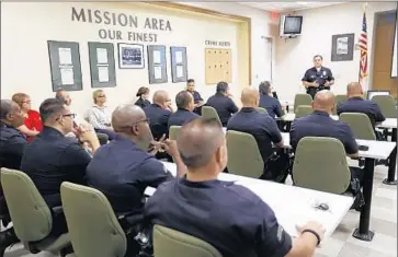  ?? Photograph­s by Al Seib Los Angeles Times ?? SGT. DAN GOMEZ of the informatio­n technology bureau briefs Mission Division officers Monday as the LAPD begins rolling out 7,000 body cameras. “This is a big moment for us,” Capt. Todd Chamberlai­n said.