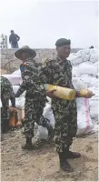  ?? PRaKESH MATHEMA/AFP/GETTY IMAGES ?? Nepali Army personnel collect waste from Mount Everest before it is recycled in Kathmandu.