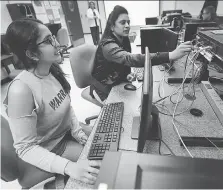  ?? DAN JANISSE ?? Trushna Patel, left, and Annette Inja, computer networking students at St. Clair College, work in a lab class on Thursday.