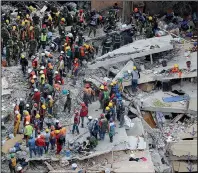  ?? AP/REBECCA BLACKWELL ?? Rescue workers search for people trapped inside a collapsed building Wednesday in the Del Valle area of Mexico City.