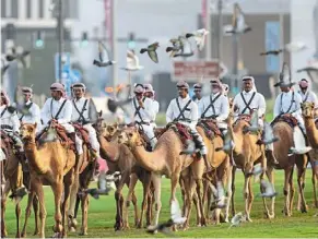  ?? ?? Along for the ride: royal guards patrol on camels before the start of the World Cup in doha. — ap