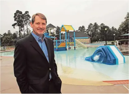  ?? Jimmy Loyd / For the Chronicle ?? Fall Creek general manager Rusty Campbell stands by a children’s pool, one of the amenities available in the popular family friendly community in the Humble area.