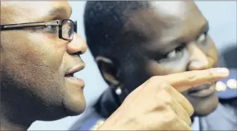  ?? PICTURE: BRENTON GEACH ?? Police Minister Nathi Mthethwa, talks to national police commission­er Mangwashi Phiyega in Parliament yesterday after he released the latest crime statistics.