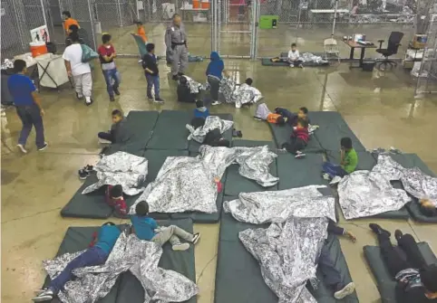  ?? AFP photo ?? This U.S. Customs and Border Protection photo obtained June 18 shows intake of illegal border crossers by U.S. Border Patrol agents at the Central Processing Center in Mcallen, Texas, on May 23.