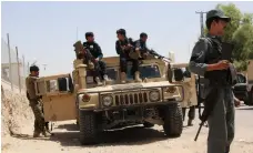  ?? AFP ?? Afghan security personnel search for Taliban fighters in Gereshk district of Helmand, where the air strike hit a compound