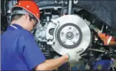  ?? BLOOMBERG ?? An employee installs brake pads on a BYD vehicle at the firm’s assembly plant in Shenzhen, Guangdong province.