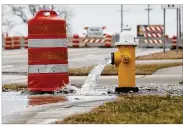  ?? TY GREENLEES / STAFF ?? An open fire hydrant flows along North Dixie Drive near the Great Miami River as part of a reaction to restore water service from the City of Dayton’s water system on Thursday. A large water main broke late Wednesday and the city was able to bypass the break.