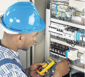  ??  ?? An electricia­n examines a fusebox. Sub-contractor­s are prone to exploitati­on in the building industry, says Jantji Mahlangu.