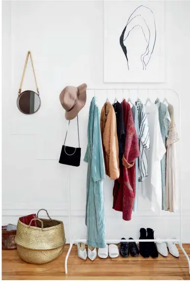  ??  ?? ABOVE Sure, not having a single closet in your small studio apartment can be problemati­c, but Lauren turned a design limitation into a stunning statement: She made an artistic vignette of a dressing area using a diminutive clothing rack hung with a few...