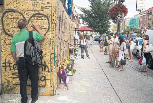  ?? CARLOS OSORIO/TORONTO STAR ?? The growing memorial on the Danforth, seen on Wednesday. After the deadly shooting, places of worship opened their doors to mourners.