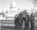  ??  ?? AFTER THE STORM — Security staff are seen near the US Capitol building a day after supporters of US President Donald Trump stormed it in Washington, D.C., the United States, Jan. 7, 2021. (Xinhua)