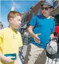  ?? DAX MELMER/The Windsor Star ?? Brian Deschamps and his son, Latham, 8, walk in Walkervill­e.