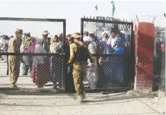  ?? AFP VIA GETTY IMAGES ?? Asylum seekers wait to enter Afghanista­n through the Pakistan-afghanista­n border crossing point on Friday.